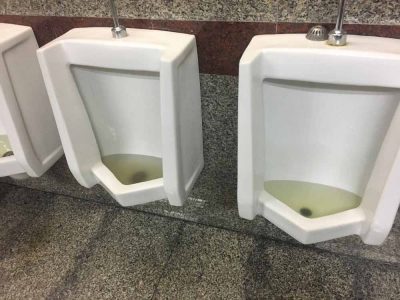 clogged toilet in a commercial bathroom